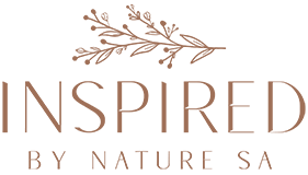 "INSPIRED BY NATURE SA" logo in soft brown text with a botanical branch illustration above, displayed on a transparent background.
